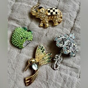 Four brooches! 🍎🐘🕊️☂️